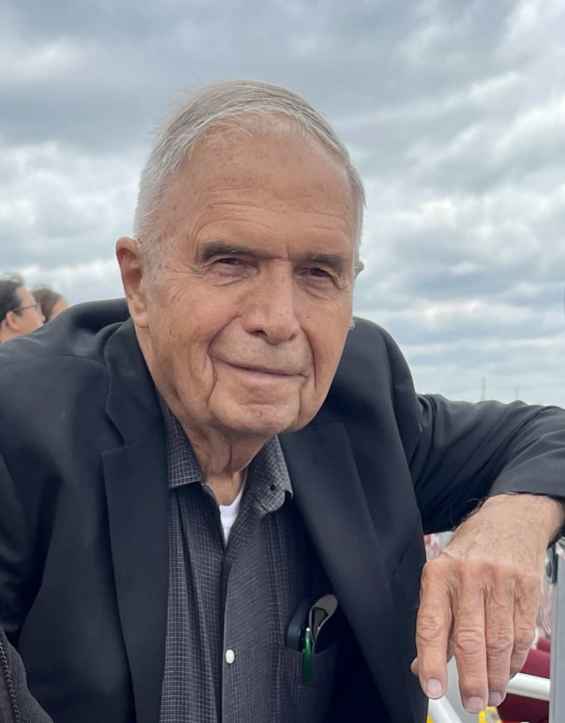 Gary Guttau smiling under a cloudy sky